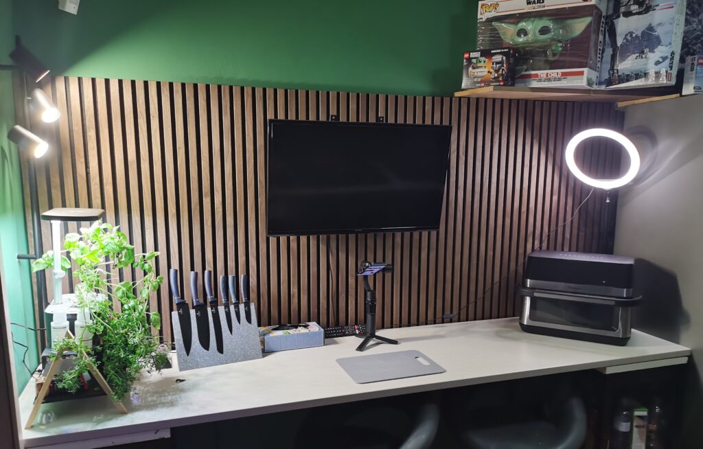 Modern home office setup with plants and tech gadgets